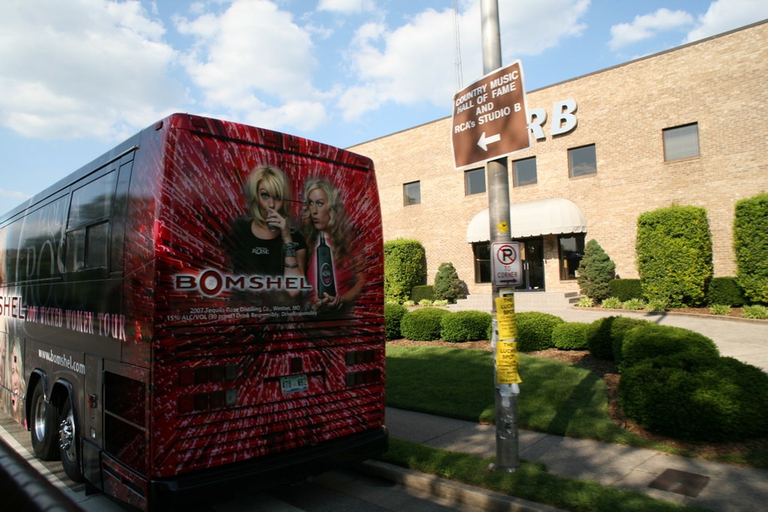 The exterior of a brick building labeled as 'Country Music Hall of Fame and RCA's Studio B' with a promotional tour bus parked outside. This represents a physical location in the music industry that likely contains offices, though the image focuses on the exterior rather than office spaces.
