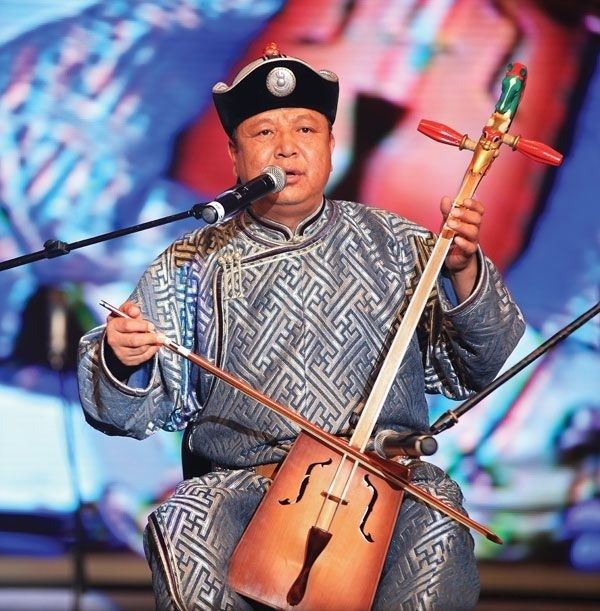 Tuvan musician singing while playing a bowed morin khuur