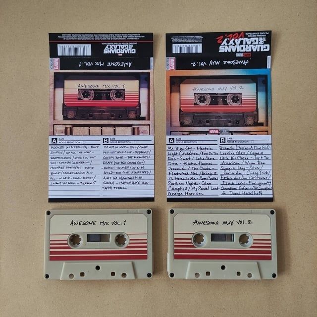Two labeled mixtapes and their handwritten track lists arranged on a surface